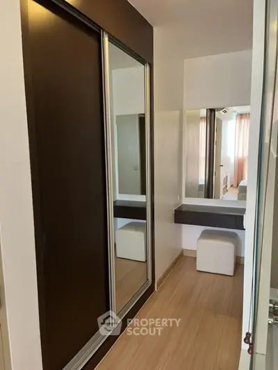 Modern bedroom with mirrored wardrobe and stylish seating area