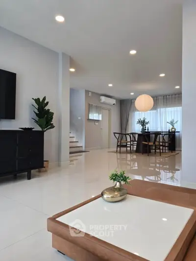Modern living room with elegant dining area and stylish decor