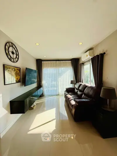 Modern living room with sleek furniture and large windows for natural light