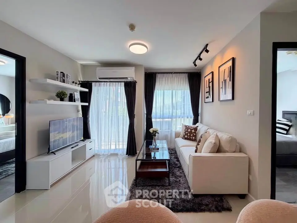 Modern living room with sleek design, featuring a cozy sofa, stylish decor, and ample natural light.