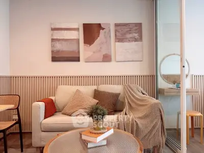 Cozy living room with modern decor, featuring a comfortable sofa and stylish wall art.