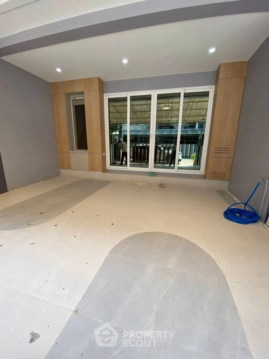 Spacious modern room with large windows and sleek design, perfect for versatile use in any home.