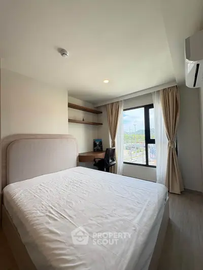Modern bedroom with large window and scenic view, featuring a comfortable bed and stylish decor.