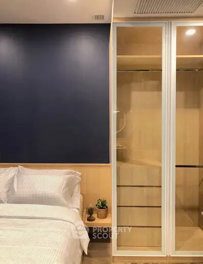 Modern bedroom with sleek closet and cozy bed in stylish apartment