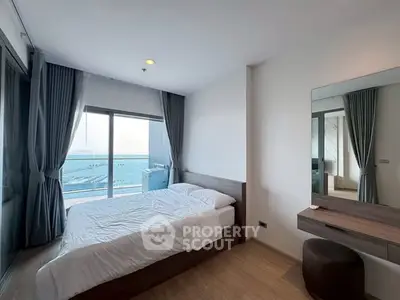 Stunning bedroom with ocean view and modern furnishings in a luxury apartment.
