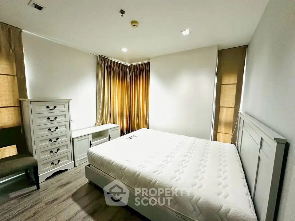 Spacious bedroom with elegant furniture and natural light