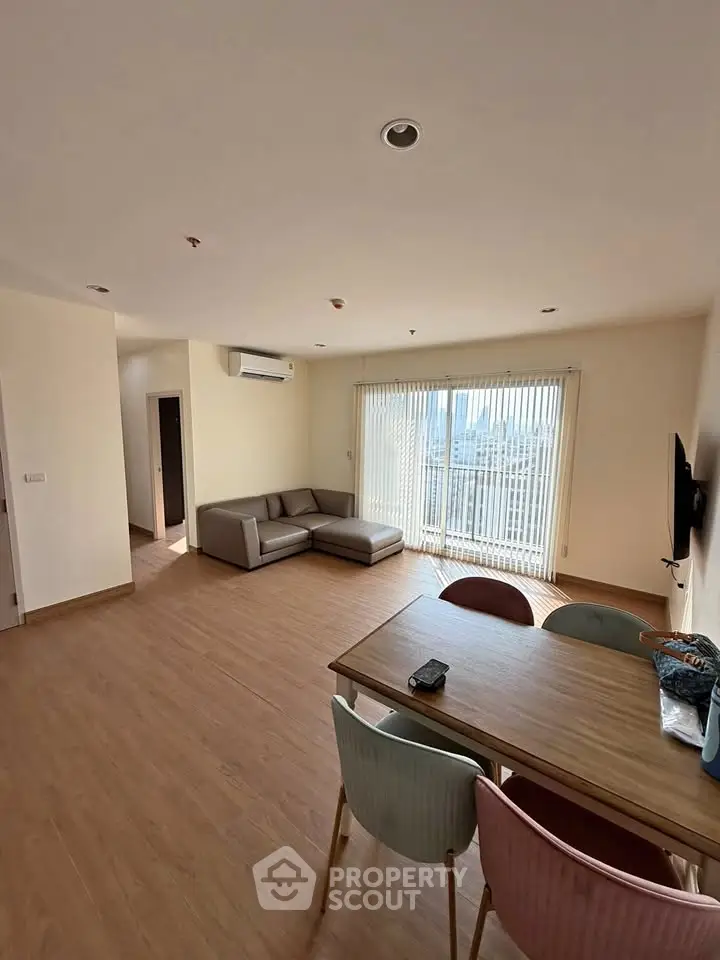 Spacious living room with modern furniture and large window view