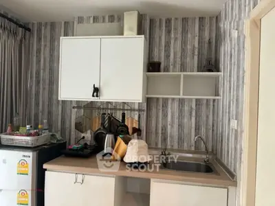 Charming compact kitchen with modern appliances and stylish backsplash