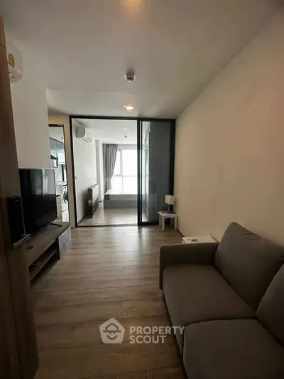 Modern living room with sleek design and natural light, featuring a cozy sofa and stylish decor.