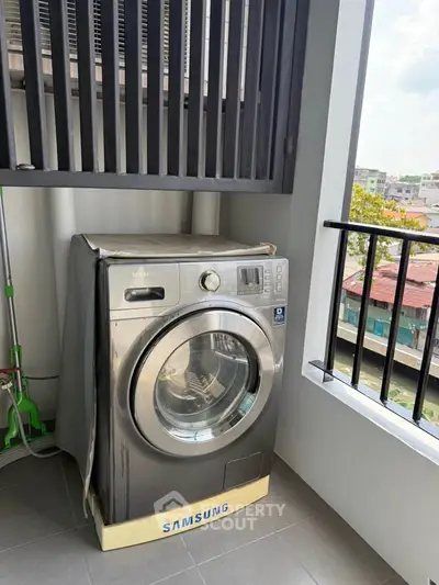 Modern balcony with Samsung washing machine and city view, perfect for urban living convenience.