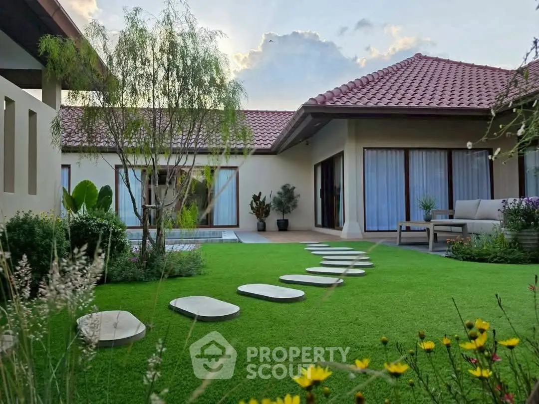 Charming modern home with lush garden and stepping stones, perfect for serene outdoor living.