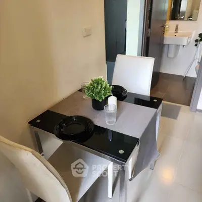 Modern dining area with sleek table and chairs, adjacent to a stylish bathroom.