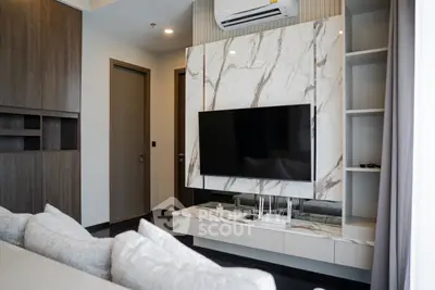 Modern living room with marble TV wall and sleek furniture