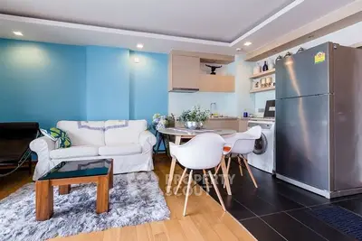 Modern open-plan living room with stylish furniture and kitchen appliances