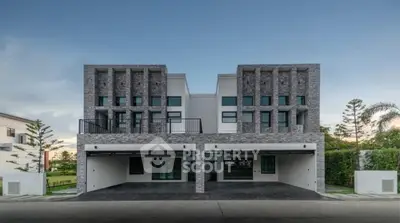 Modern duplex with sleek design and spacious garage in serene neighborhood.