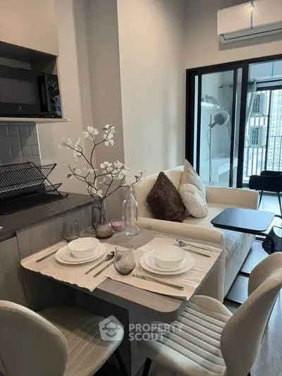 Modern living room with dining area, cozy sofa, and elegant decor in a stylish apartment.
