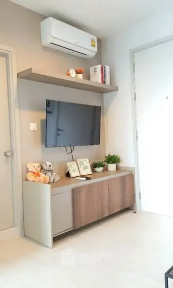 Modern living room with wall-mounted TV and air conditioning unit