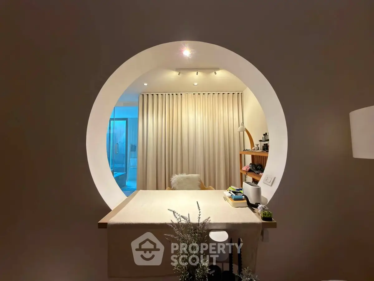 Modern interior with circular wall opening and cozy decor