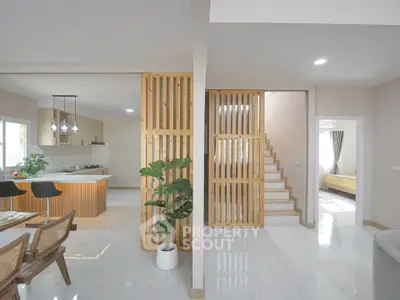 Modern open-plan living area with stylish kitchen and wooden accents