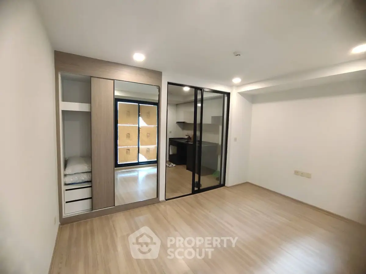 Spacious modern bedroom with sliding glass doors and built-in wardrobe