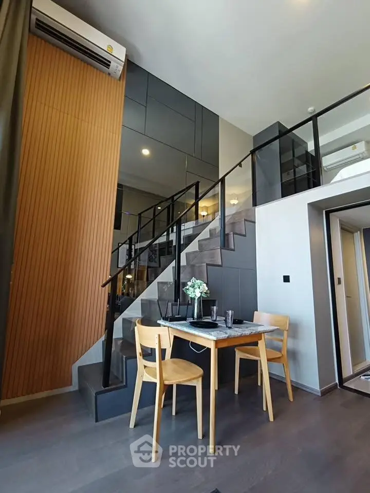 Modern duplex apartment with stylish staircase and dining area