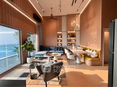 Luxurious modern living room with high ceilings, elegant decor, and stunning balcony view.