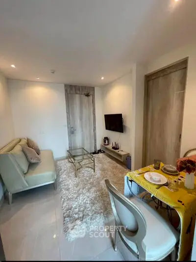 Chic modern living room with cozy seating and stylish decor, perfect for urban living.