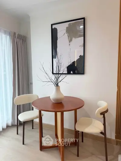 Chic modern dining nook with stylish round table and elegant chairs, perfect for cozy meals.