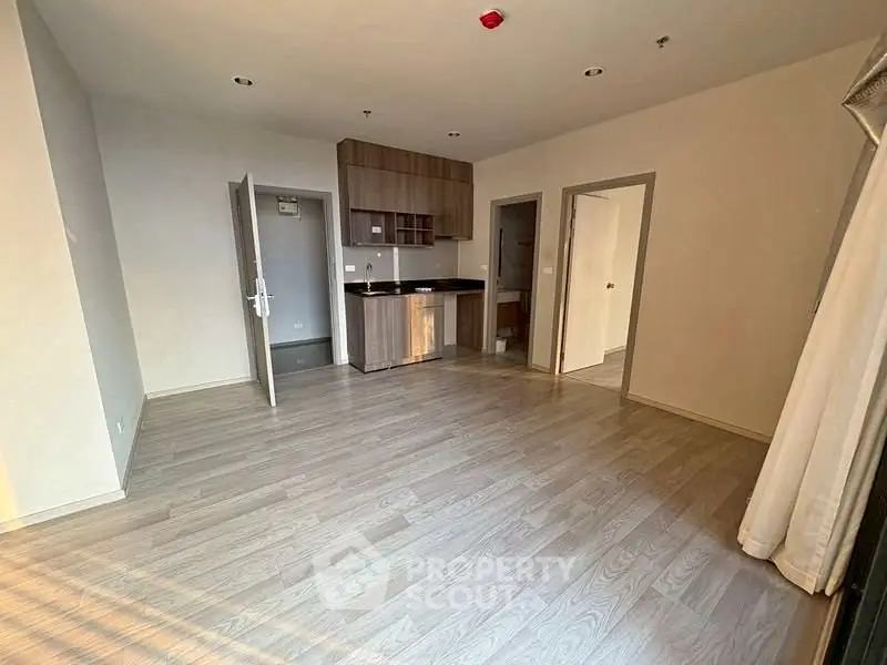 Spacious modern living room with open kitchen and wooden flooring