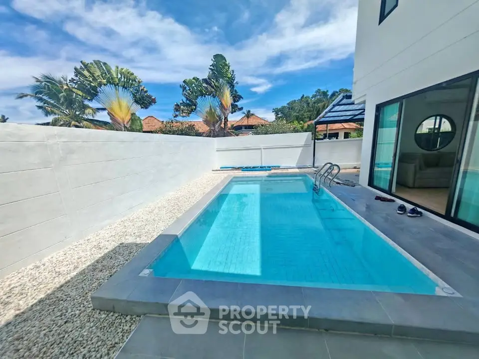 Luxurious private pool with modern design in a serene backyard setting