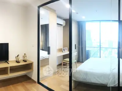 Modern bedroom with large window and city view, featuring sleek furniture and wooden flooring.