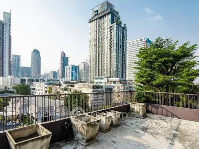 Stunning cityscape view from a spacious balcony in a high-rise building, perfect for urban living.