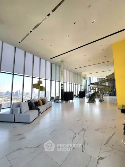Luxurious high-rise living room with floor-to-ceiling windows and stunning city views.