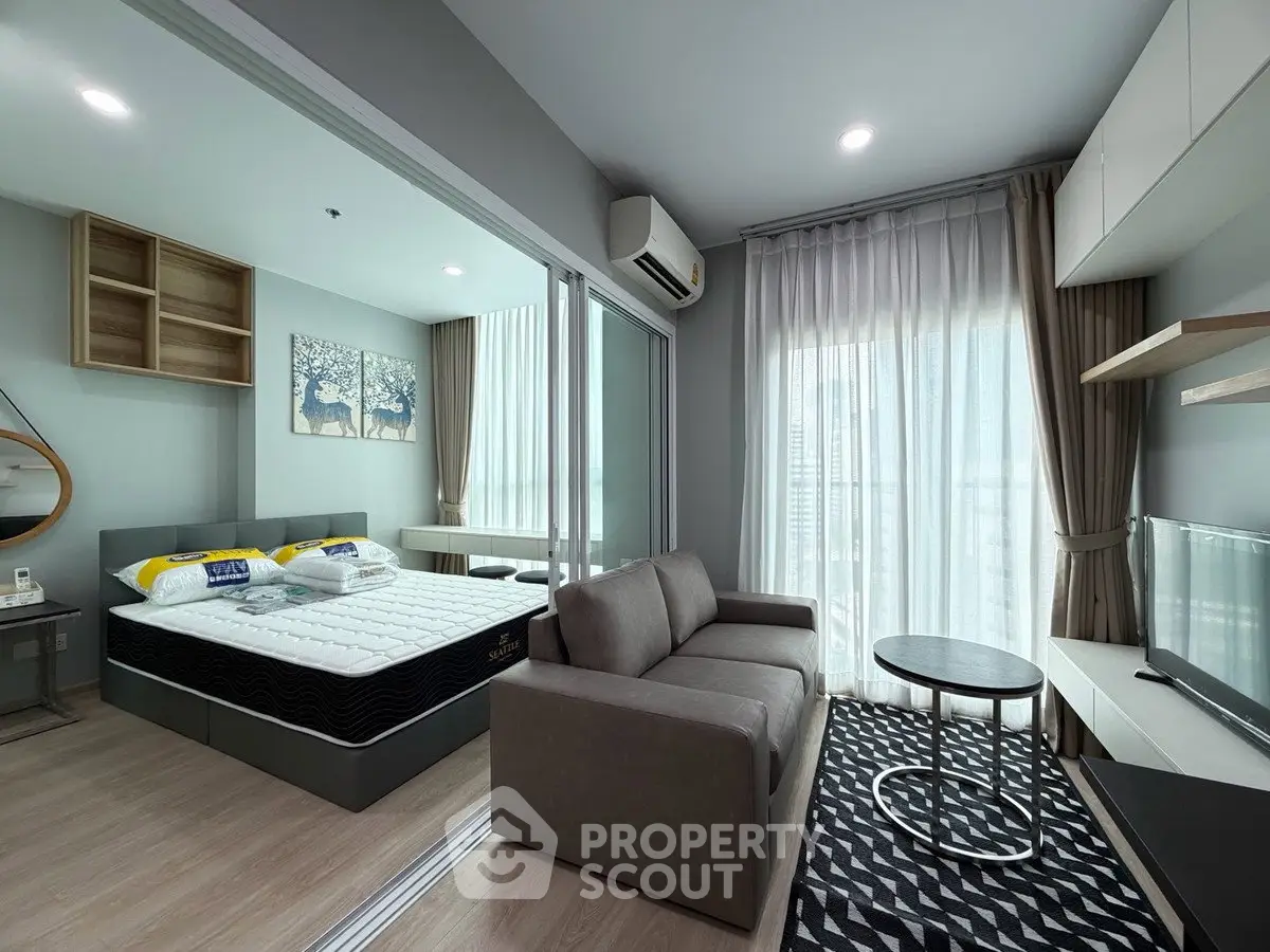 Modern studio apartment with cozy living area and bedroom, featuring stylish decor and natural light.
