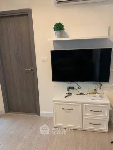 Modern living room with wall-mounted TV and stylish storage unit