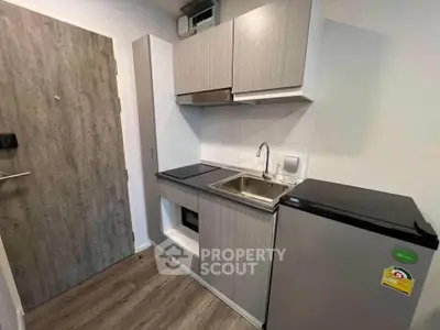 Compact modern kitchen with sleek cabinetry and stainless steel appliances