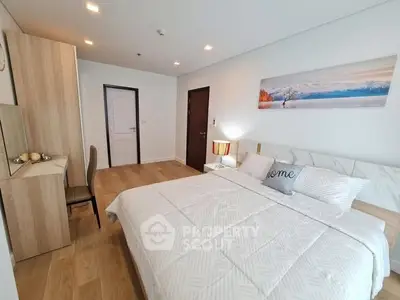 Spacious modern bedroom with elegant decor and natural lighting