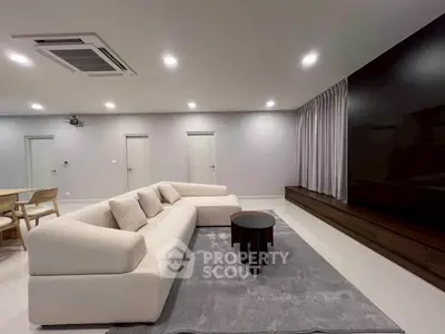 Spacious modern living room with sleek furniture and ambient lighting