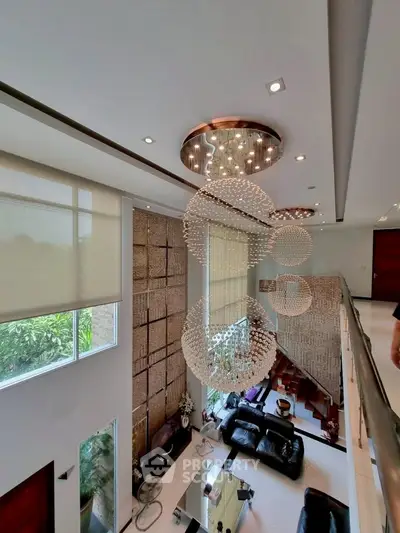 Luxurious living room with high ceilings and elegant chandeliers