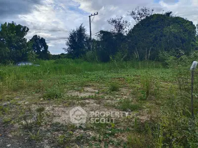 Spacious vacant land plot surrounded by lush greenery, ideal for development opportunities.