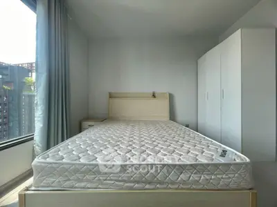 Modern bedroom with minimalist design, featuring a comfortable bed and ample storage space.