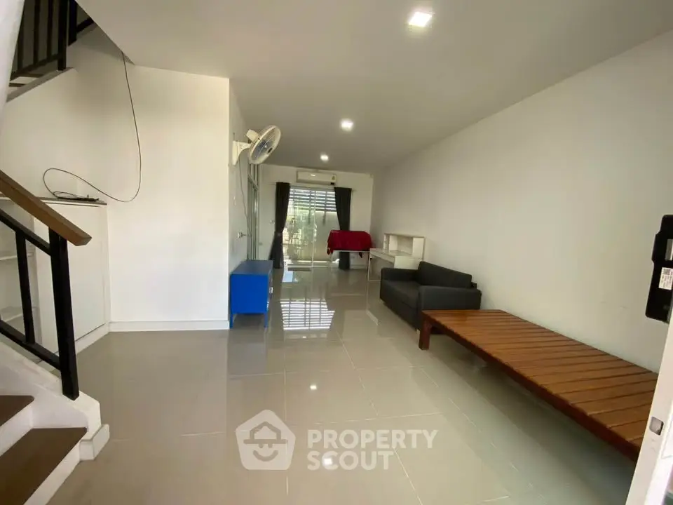 Spacious modern living room with sleek tile flooring and minimalist furniture