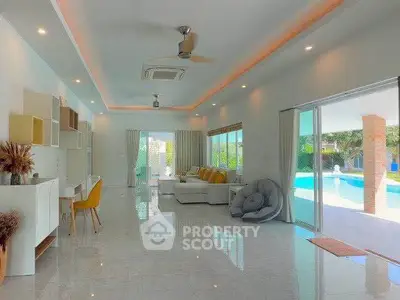 Spacious modern living room with pool view and elegant decor