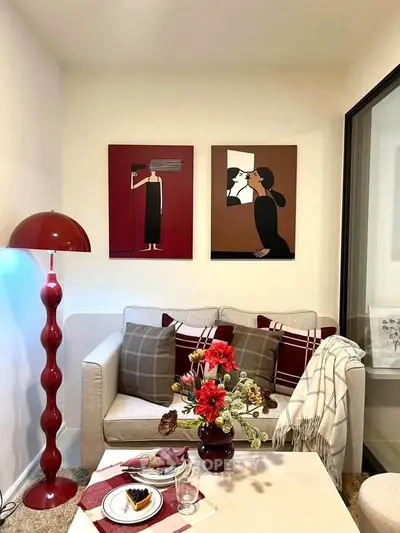 Chic living room with modern art, cozy sofa, and stylish decor accents.