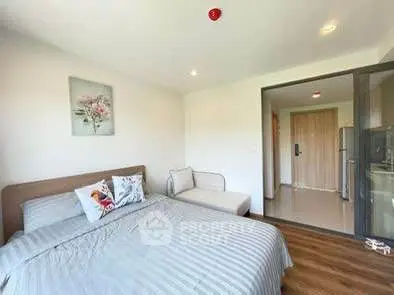 Modern bedroom with cozy decor and natural light, featuring a comfortable bed and stylish furnishings.