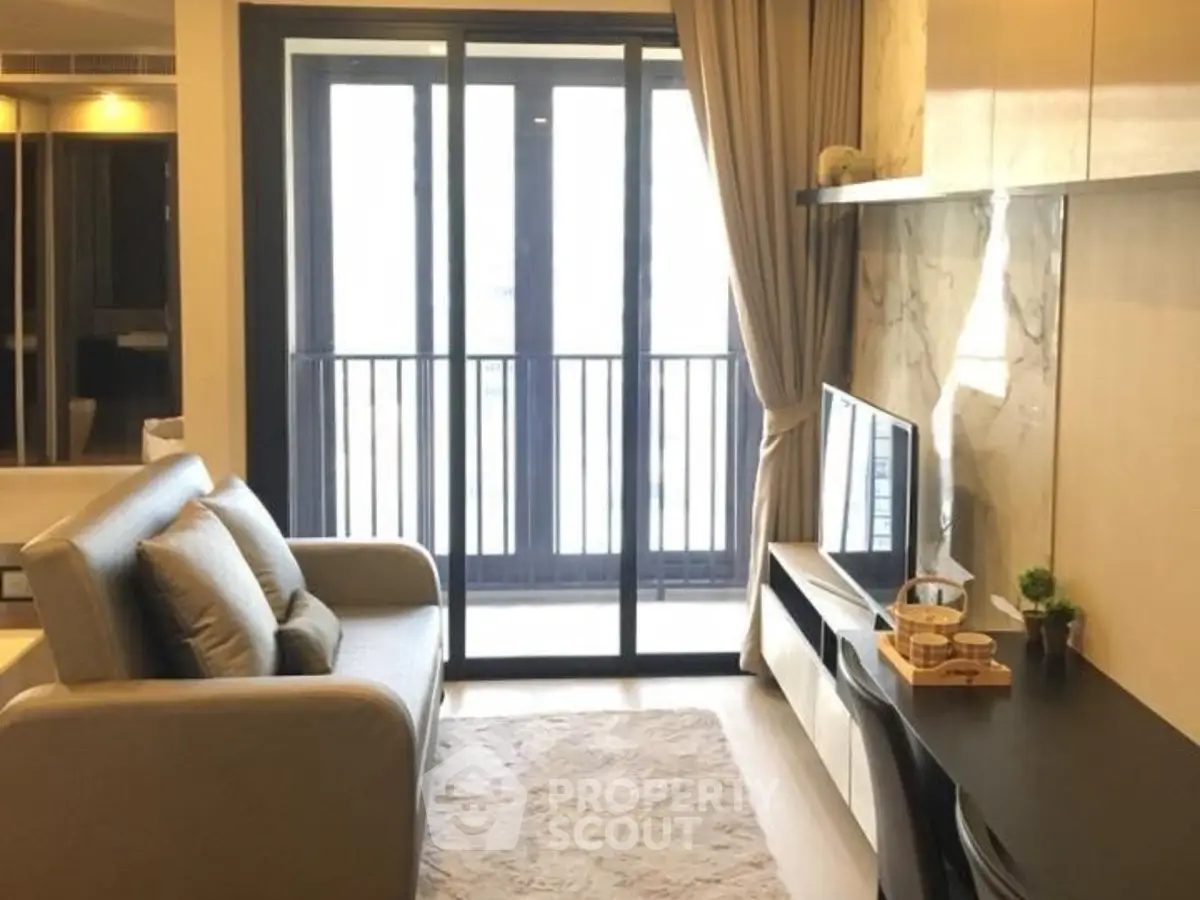 Modern living room with sleek furniture and balcony view