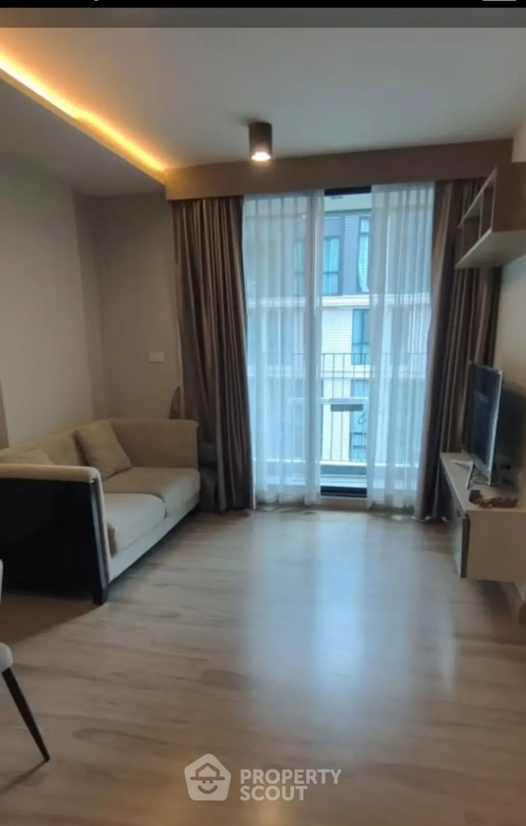 Modern living room with cozy sofa and large window view