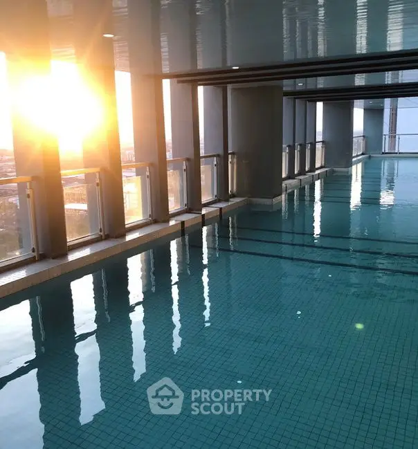 Luxurious indoor pool with panoramic city views and modern design, perfect for relaxation and leisure.