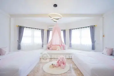 Charming children's bedroom with plush decor and elegant lighting