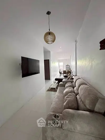 Spacious living room with modern decor and plush seating in a contemporary home.